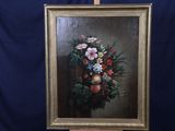 une photo d'un tableau représentant des fleurs et des fruits, posé sur un chevalet