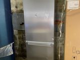 a silver refrigerator and a blue refrigerator in a room