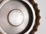 a close up of a bottle cap on a white surface