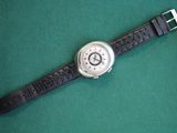 a watch that is sitting on a green surface
