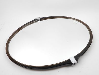 a close up of a mirror on a table with a white background