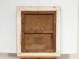 an old wooden easel with a painting on top of it in a room