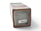 a small box with a sticker on it on a white surface