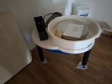 a white sink sitting on top of a wooden floor