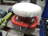 a picture of a red and white sander sitting on top of a wooden pallet