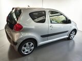 a picture of a small silver car parked in a garage