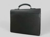a black briefcase sitting on top of a white surface