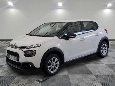 the white citrole is parked on a checkered tile floor