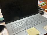 a laptop computer sitting on a desk with sticky notes on it