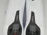 the soles of a pair of white and black shoes on a white surface