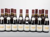 six bottles of wine lined up in a row on a table