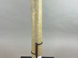 a tall glass vase on a metal stand with a black base