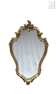 an image of a gold framed mirror on a white wall