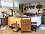 a kitchen with a counter, chairs, cabinets, and a mirror