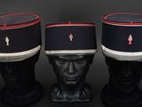 three hats on a mannequin head with red trims