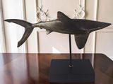 a sculpture of a shark on a stand on a table