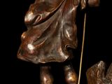 bronze statue of a man with a staff and a dog on a marble base