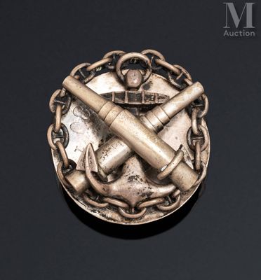 a silver medal with a hammer and anchor on it