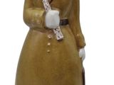 a ceramic figurine of a man with a bird on his shoulder