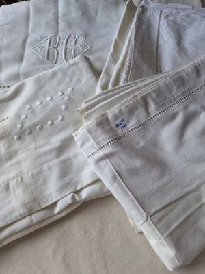 deux paires de pantalons blancs posées sur un lit