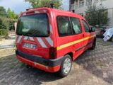a red van that is parked on the side of the road