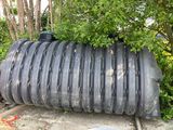 a large black tank that has a lot of tires on it