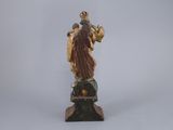 statue of a woman holding a basket of flowers on a pedestal