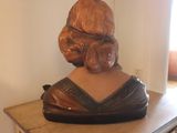 a statue of a woman sitting on top of a table