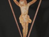 a close up of a metal cross with a person on it