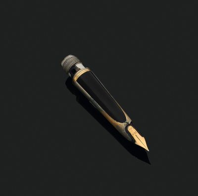 a pen that is laying on the ground with a black background