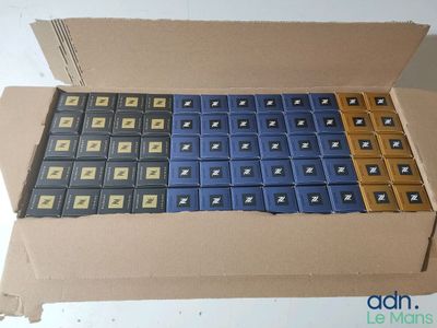 a cardboard box that has a bunch of blue and yellow batteries in it