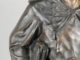a statue of a man with a book in his hand