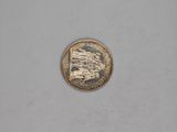 a close up of a small coin on a white surface