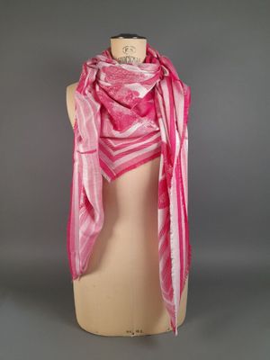 a pink and white striped scarf on a mannequin mannequin