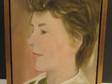 portrait of a young girl in a green dress by a gold frame