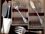 silverware in a wooden box with utensils and spoons in it