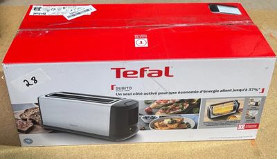 une boîte contenant un grille-pain Tefal posée sur une table