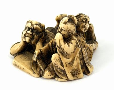 two figurines of a woman and a man laying on a bed