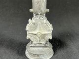 an old silver figurine of a man with a hat on his head