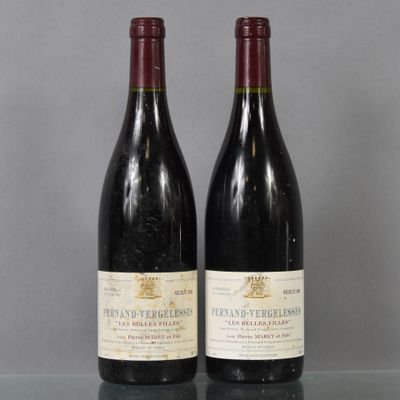 two bottles of wine sitting on top of a table next to each other