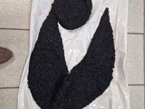a black scarf and a black hat on a plastic bag