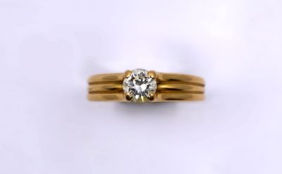a close up of a gold ring with a diamond on it