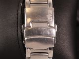a close up of a watch on a wrist on a pillow