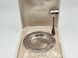 silver plate with a spoon in a box on a white surface