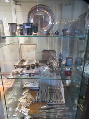 a glass case filled with silverware and silverware