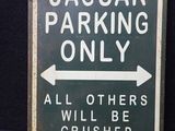 un panneau indiquant « Réservé aux Jaguar – tous les autres véhicules seront écrasés »