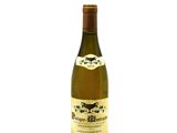 the bottle of white wine is sitting on a white surface