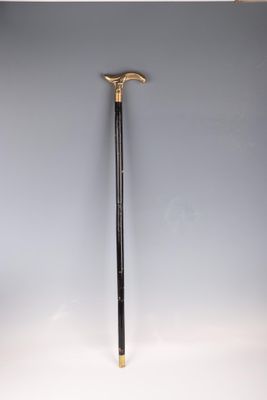 an old cane with a wooden handle on a white surface
