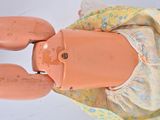 a doll that is wearing a dress and a pair of shoes