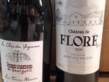 two bottles of wine sitting next to each other on a table